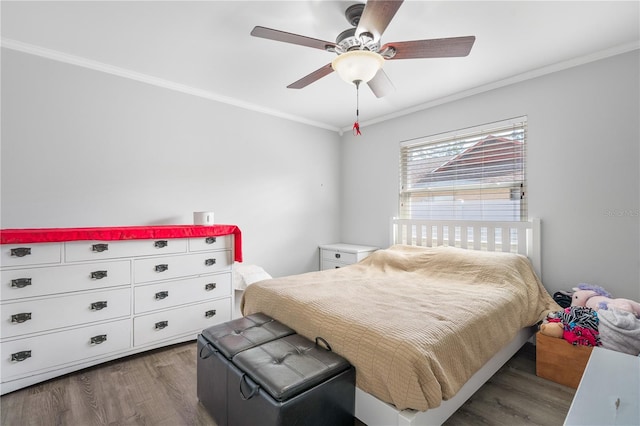 bedroom featuring dark wood-type flooring, ceiling fan, and crown molding