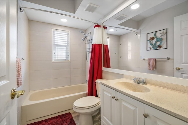 full bathroom featuring shower / bath combo, vanity, and toilet