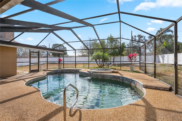 view of pool with an in ground hot tub, a patio area, and glass enclosure