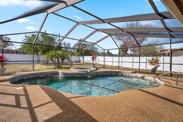 view of pool featuring a patio area, glass enclosure, and an in ground hot tub