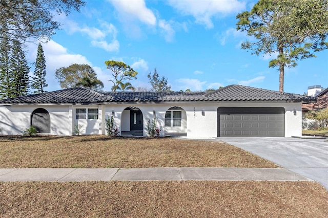 view of front of property with a garage and a front yard