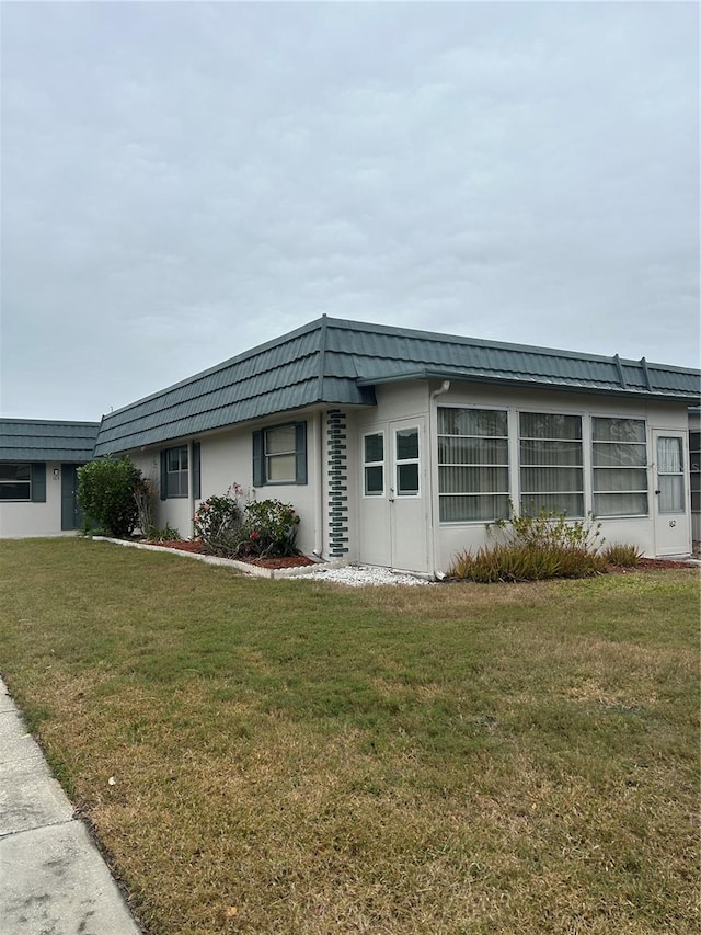 view of side of home with a yard