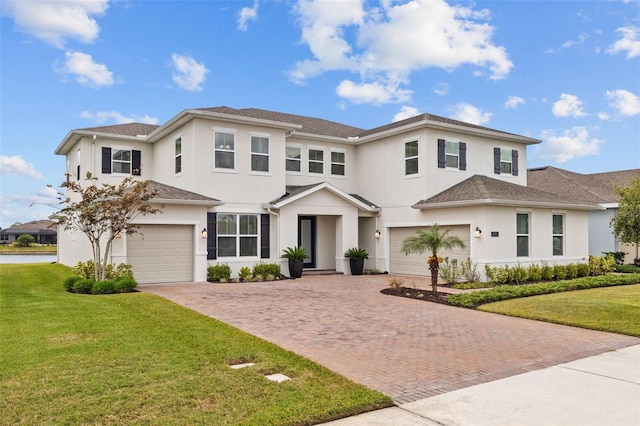 view of front facade with a garage and a front lawn