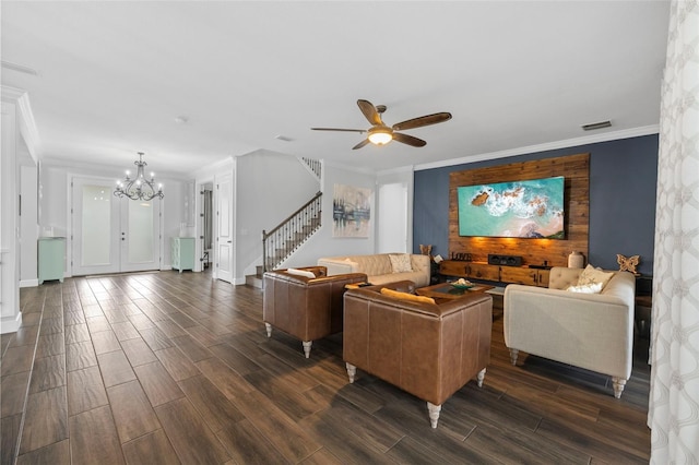 living room with crown molding and ceiling fan with notable chandelier