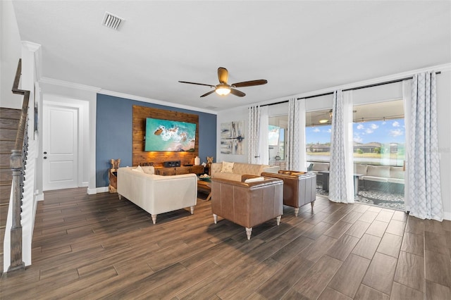 living room with ornamental molding and ceiling fan