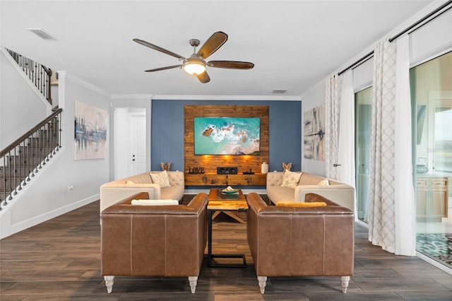 living room featuring ornamental molding, dark wood-type flooring, and ceiling fan