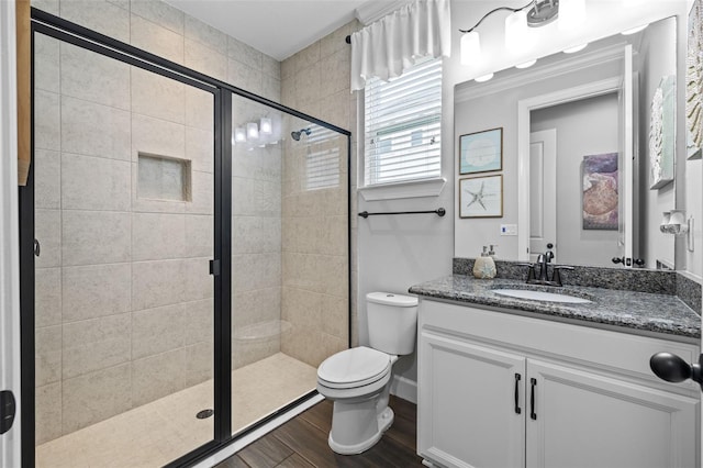 bathroom with vanity, toilet, an enclosed shower, and hardwood / wood-style floors