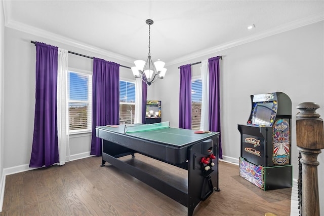 game room with crown molding, wood-type flooring, and a notable chandelier