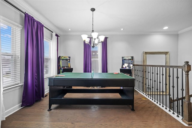 playroom with ornamental molding, dark hardwood / wood-style flooring, and a notable chandelier