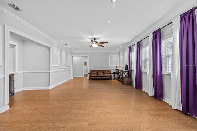 unfurnished living room featuring ceiling fan, crown molding, and light hardwood / wood-style floors