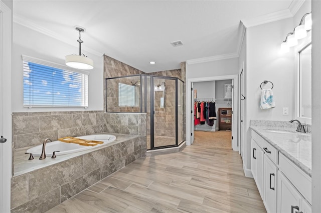 bathroom featuring crown molding, vanity, shower with separate bathtub, and wood-type flooring