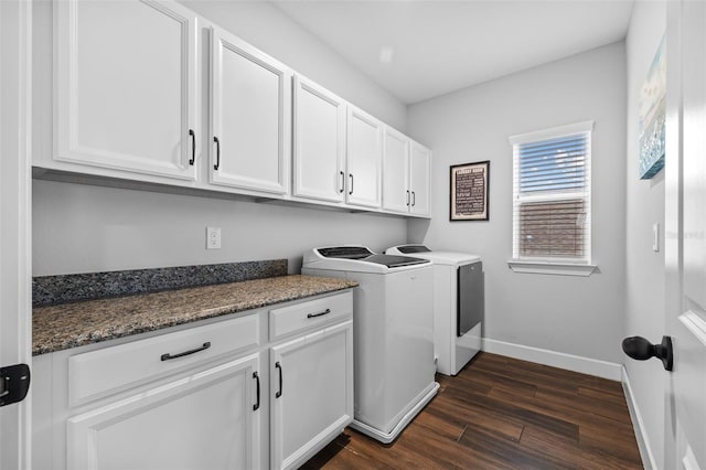 clothes washing area featuring cabinets, dark hardwood / wood-style floors, and washing machine and dryer