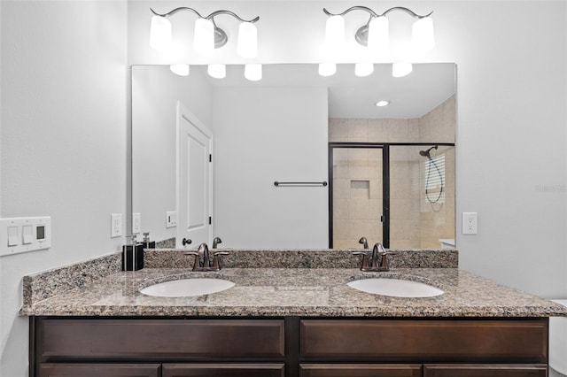 bathroom featuring vanity and an enclosed shower