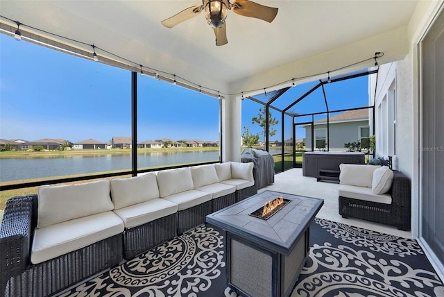 sunroom with a water view and ceiling fan