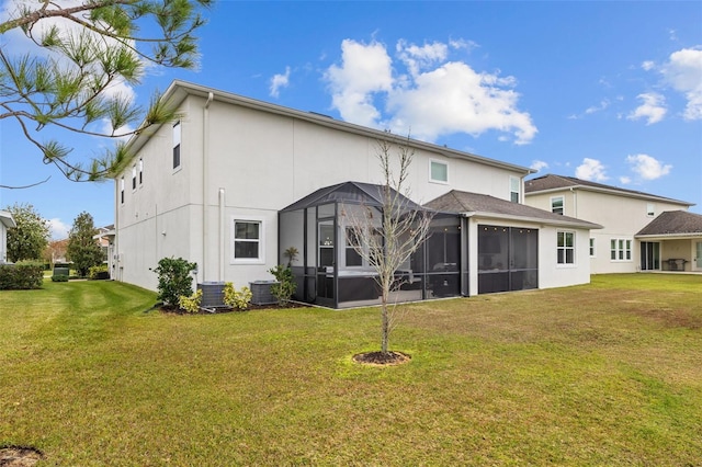 back of property with central AC, a lawn, and a sunroom