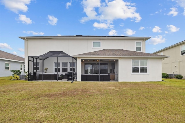 back of property featuring a lanai and a lawn