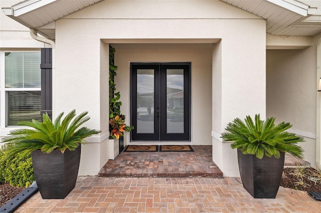 7721 Roma Dune Dr, Wesley Chapel, FL 33545 - doorway to property with french doors and stucco siding
