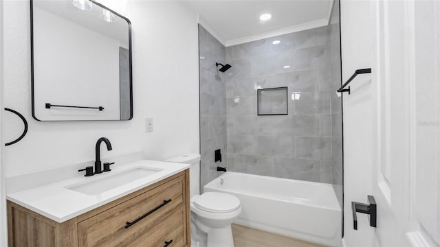 full bathroom featuring vanity, toilet, and tiled shower / bath combo