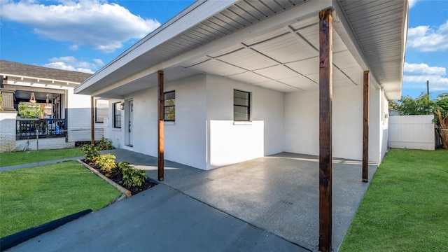 view of home's exterior with a lawn and a carport