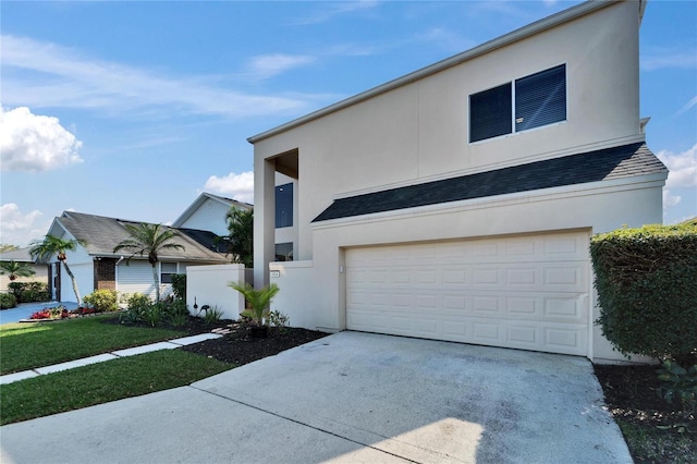 view of front facade with a garage and a front lawn