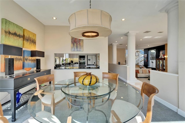 dining area featuring decorative columns