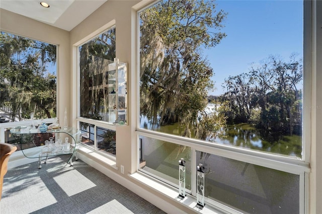 sunroom / solarium with a water view