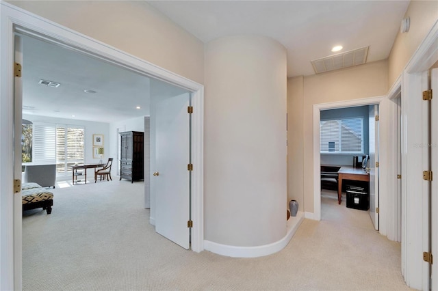 hallway with light colored carpet