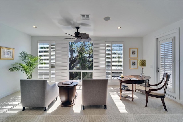 interior space with light colored carpet and ceiling fan