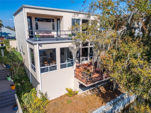 rear view of house featuring a balcony