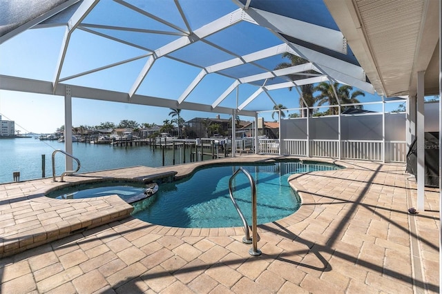 view of pool featuring a pool with connected hot tub, a water view, a patio, and a lanai