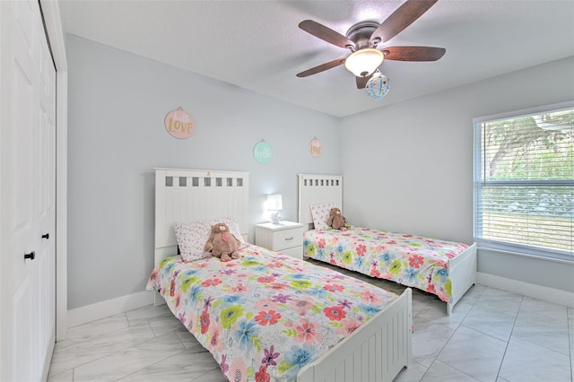 bedroom featuring a textured ceiling, a closet, and ceiling fan