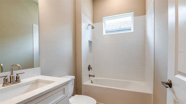 full bathroom featuring vanity, tiled shower / bath, and toilet