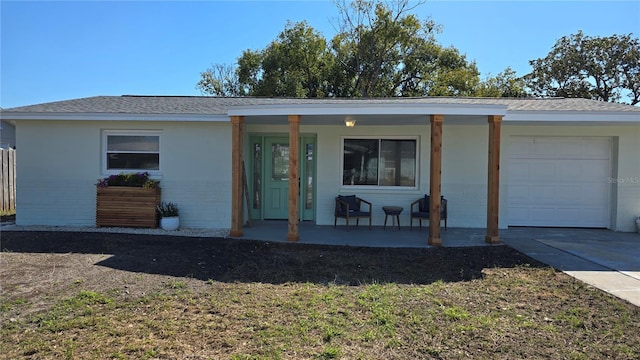 ranch-style house with a garage and a porch