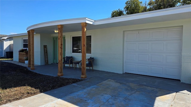 exterior space featuring a garage and covered porch