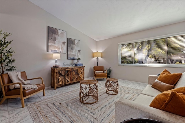 living room with vaulted ceiling and baseboards