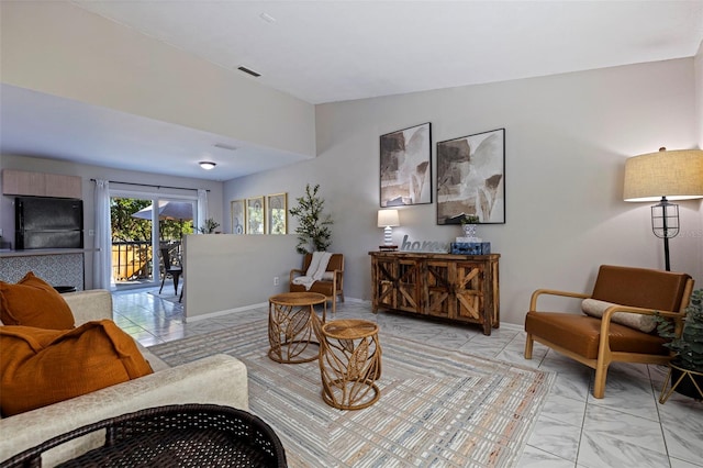 sitting room featuring visible vents, marble finish floor, and baseboards