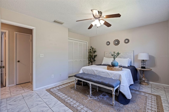 bedroom with baseboards, visible vents, ceiling fan, a closet, and marble finish floor