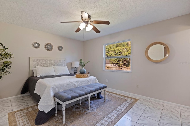 bedroom with baseboards, a textured ceiling, and ceiling fan