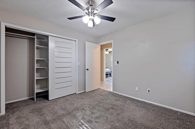 unfurnished bedroom with baseboards, a closet, carpet floors, and a textured ceiling