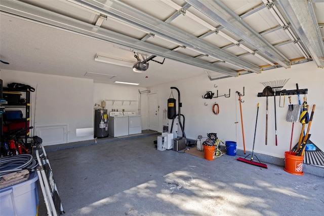 garage with independent washer and dryer, a garage door opener, and water heater