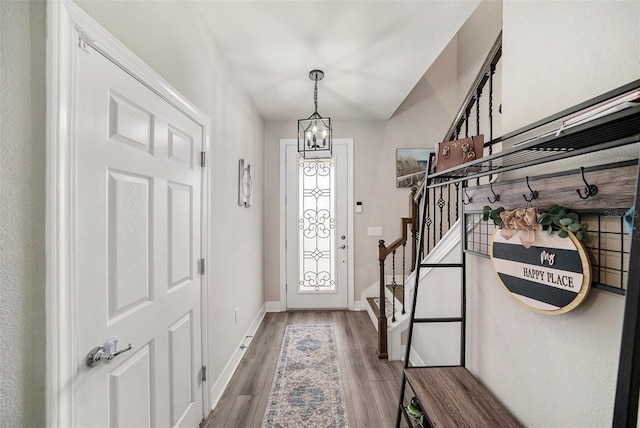 entrance foyer featuring hardwood / wood-style flooring and a chandelier