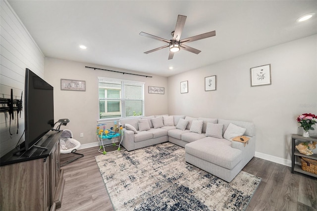 living room with hardwood / wood-style flooring and ceiling fan