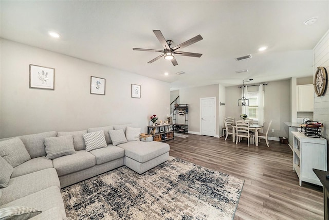 living room with hardwood / wood-style flooring and ceiling fan