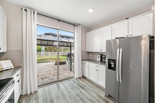 kitchen with white cabinetry, stone countertops, and appliances with stainless steel finishes