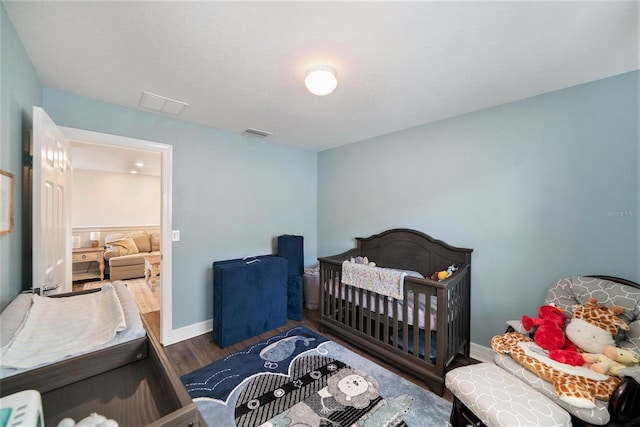 bedroom with dark hardwood / wood-style flooring