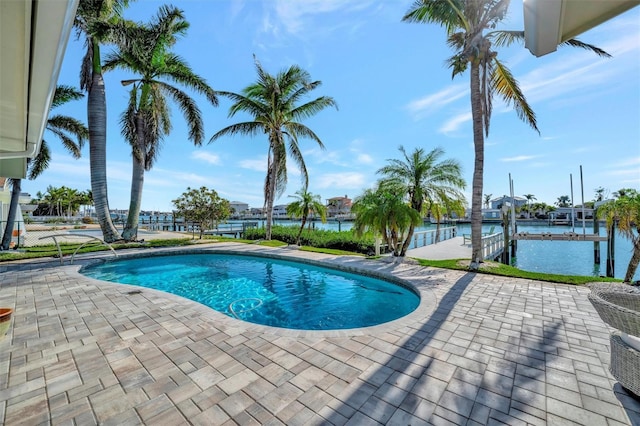 view of pool with a dock and a water view