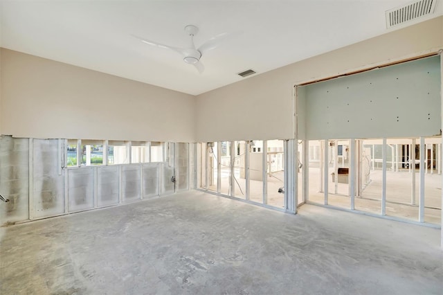 unfurnished room with concrete flooring and ceiling fan