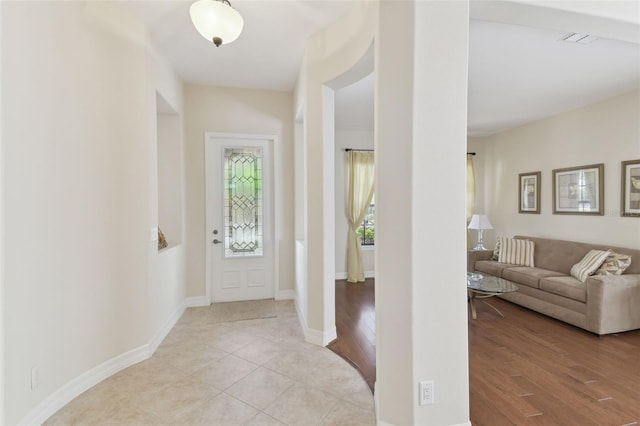 entrance foyer featuring visible vents, light wood-style flooring, and baseboards