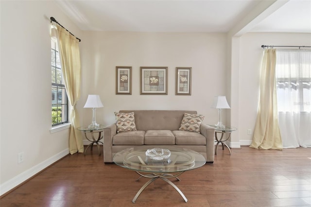 living area with wood finished floors and baseboards