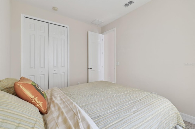 bedroom featuring visible vents and a closet